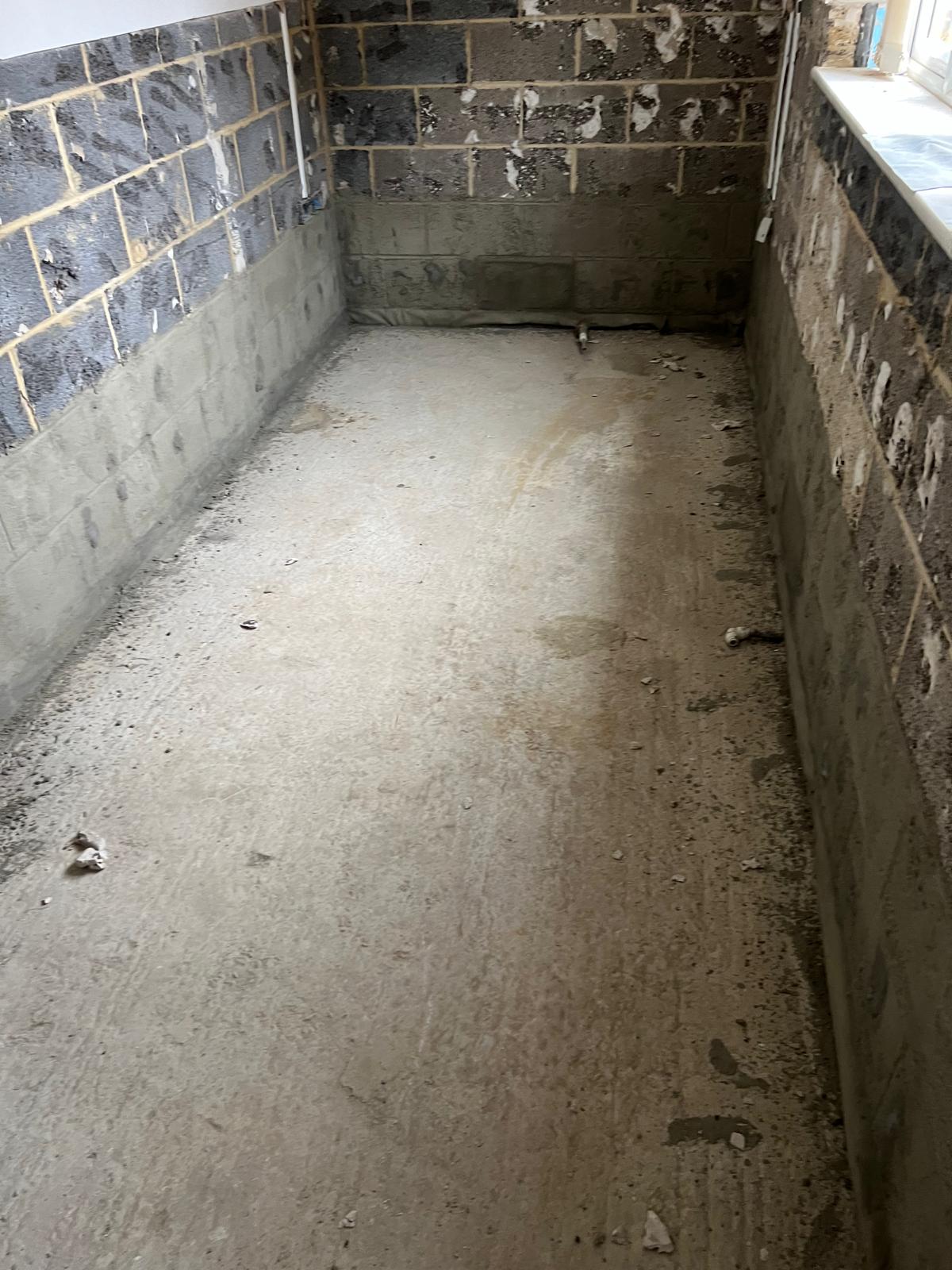 The insurer's first reinstatement attempt — cement fillet applied over the DPM before it failed to bond