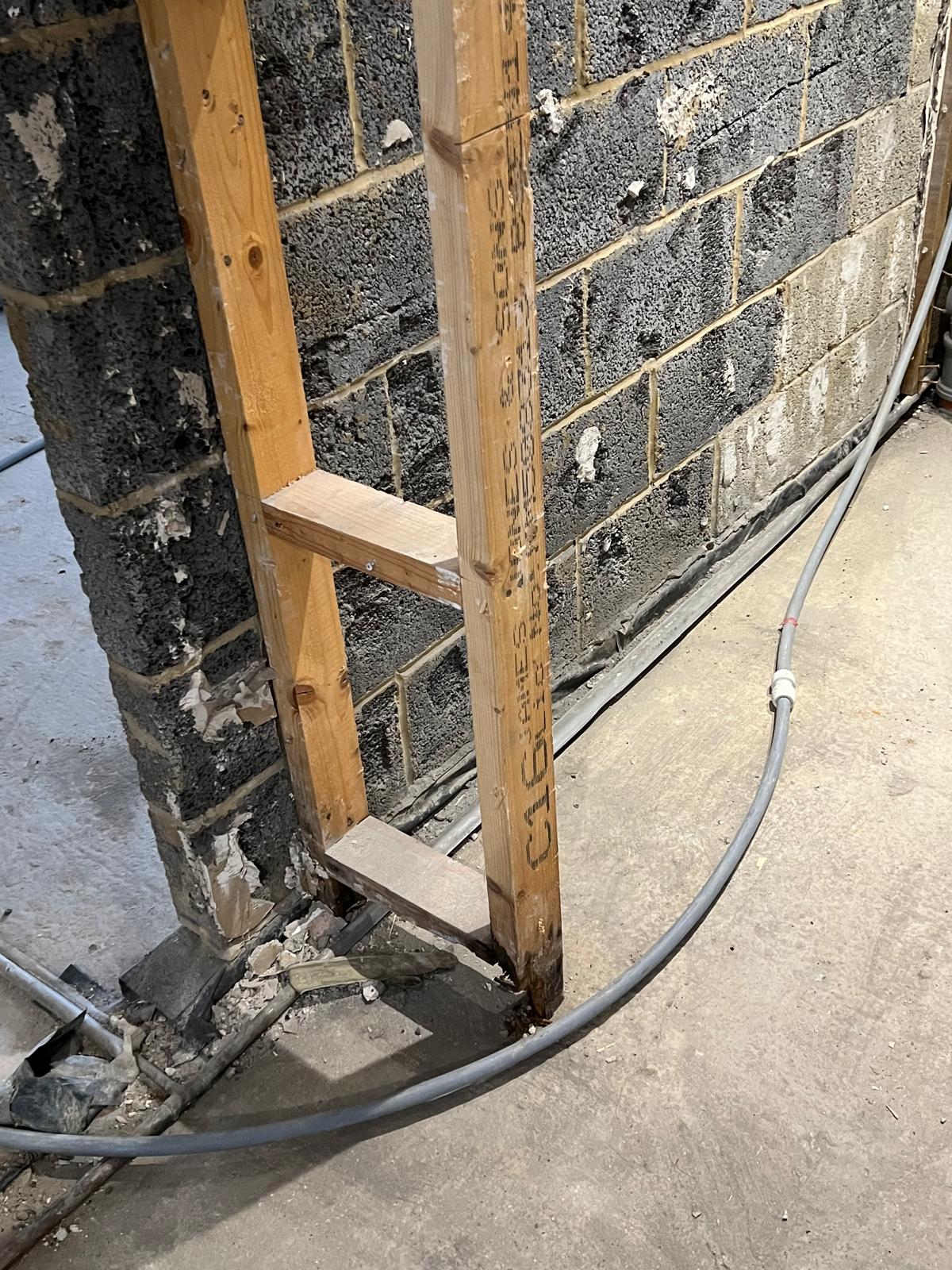 Rotted timber in the stud wall — hidden damage the insurer never properly assessed