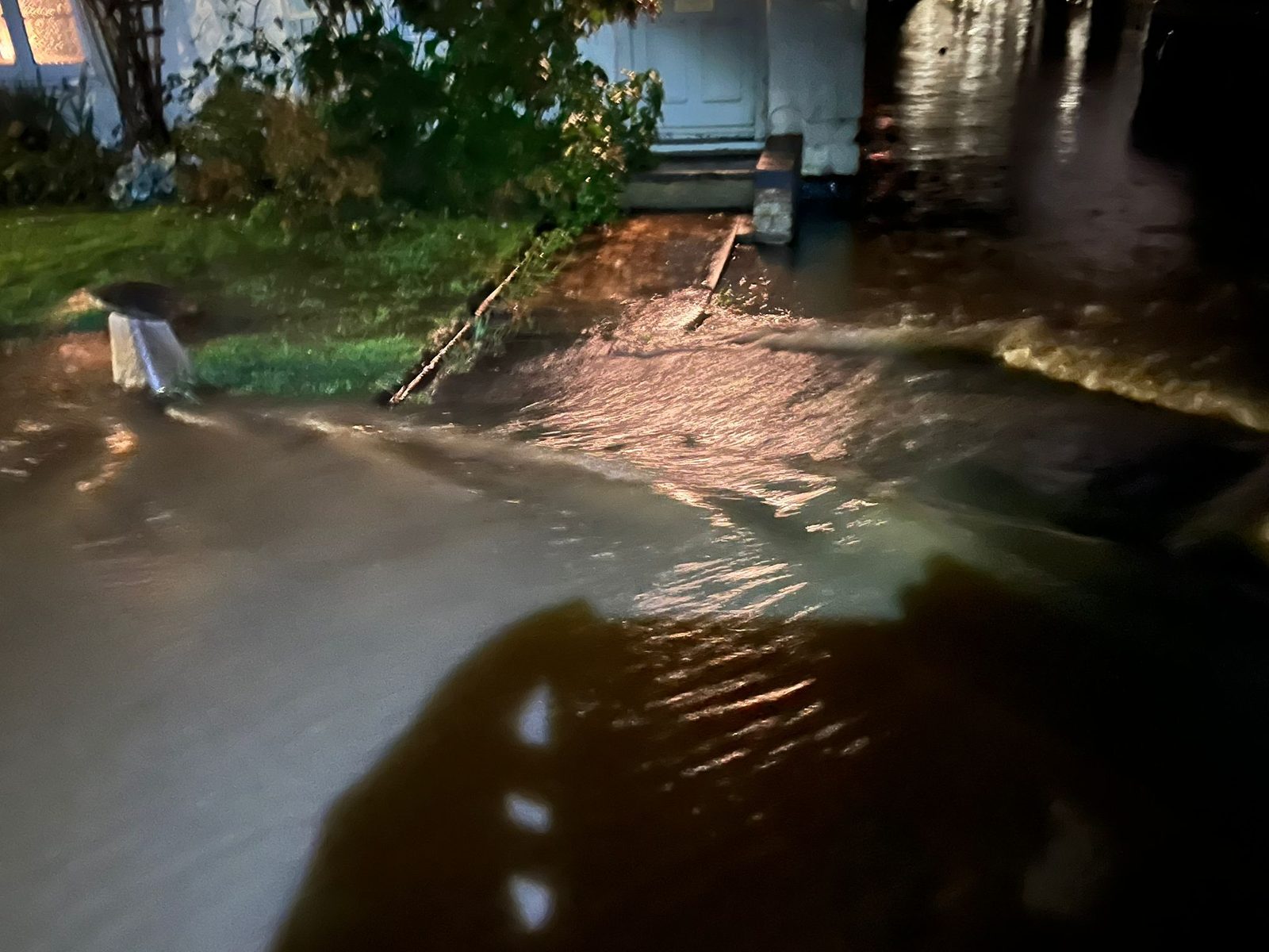 The current of water flowing down Main Street, Gawcott — September 2024